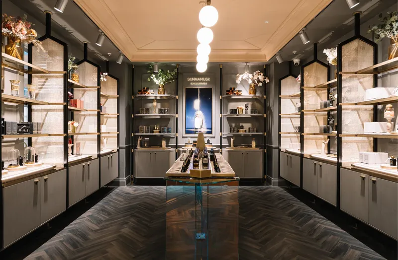 Dark boutique with brass fixtures and herringbone floors